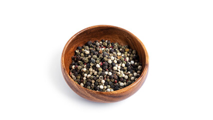 Pepper mixture in a wooden bowl isolated on a white background.