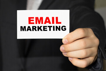 Card with text EMAIL MARKETING on hand. You can use in business, marketing and other concepts. Messege of the day.