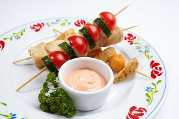 chicken kebab with sauce and herbs