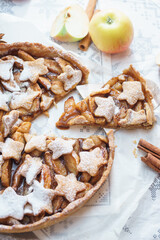 Traditional apple pie on the table with decorations.