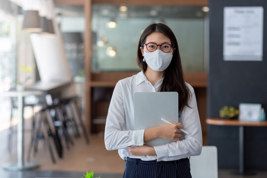 Asian Business Woman Wear A Mask To Prevent COVID-19 At The Office.