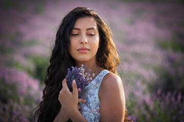 Portrait of lovely brunette girl on lavender field background.