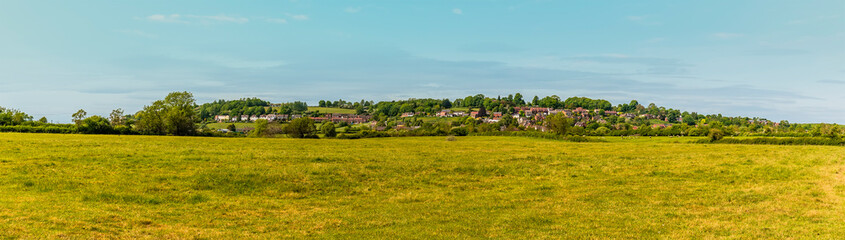 Fototapeta na wymiar A panorama view across the fields towards the village of Napton, Warwickshire in summertime