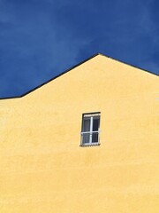 Small window frame on concrete wall building metaphor of social isolation caused by pandemic crisis