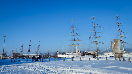 Gdynia, Poland - January 17, 2021: Polish sailing ship SV Dar Mlodziezy at the waterfront in Gdynia in winter time. The most famous city landscape.