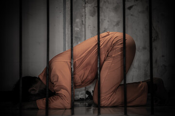 Asian man desperate at the iron prison,prisoner concept,thailand people,Hope to be free,Serious...