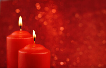 Red burning candles on red bokeh