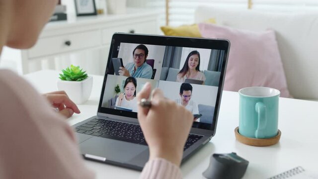 Back rear view young asian woman employee work from home using computer notebook videocall meeting conference angry annoy with low poor unreliable internet wifi connection problem issue outage.