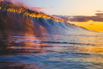 Colorful breaking wave at sunset