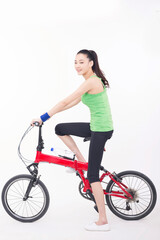 Fototapeta na wymiar Young woman riding a bicycle