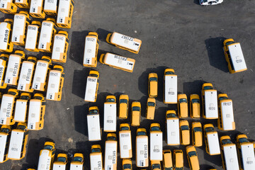 Aerial view of many yellow school buses parked at a depot