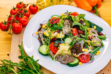salad with meat and vegetables on a decorated table