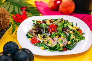 salad with meat and vegetables on a decorated table