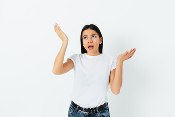 Confused young woman in t-shirt and jeans