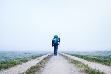 A Lone Pilgrim Girl Hiker Walking off into the Frosty Morning Fog on the Way of St James Pilgrimage...