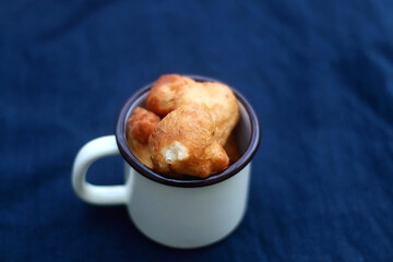 Bowl of Croatian fritters, traditional snack made with sweet fried dough. Selective focus.