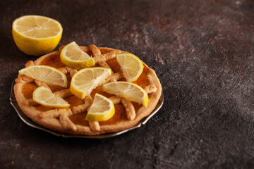 Lemon tart with copy space. Lemon shortcrust pie on concrete table