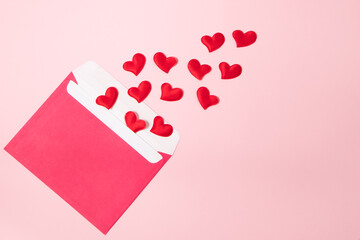 Envelope with greeting card for valentine's day. Romantic holiday concept. Hearts on a pink background.