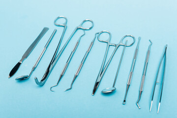 Close up view of row of dental tools on blue background