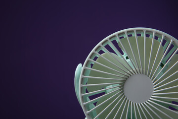 Modern electric fan on violet background, closeup. Space for text