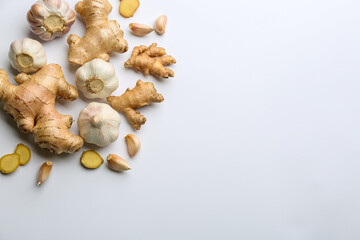Ginger and garlic on white table, flat lay with space for text. Natural cold remedies