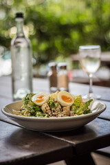 Classic Fresh Caesar Salad with cos lettuce, bacon, garlic croutons, hard boiled egg, Caesar dressing, parmesan cheese