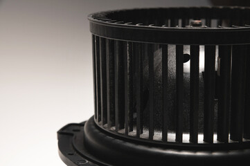 Heater motor. A spare part for an automobile heating system on a black-gray gradient background. Low key high contrast