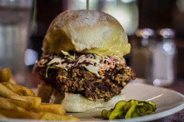 Crunchy chicken burger with slaw, swiss cheese, aioli with chips and pickles