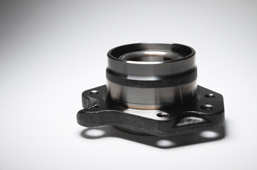 New wheel bearing in a metal housing on a black-white gradient background. New car suspension parts