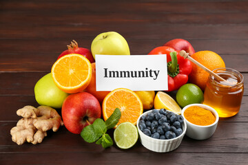 Card with word Immunity and fresh products on wooden table