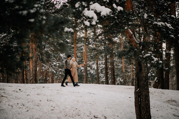 couple walking in winter forest