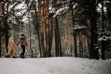 couple walking in winter forest