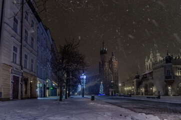 Winter in Cracow, snowy night near St. Mary's Church in Cracow marketplace