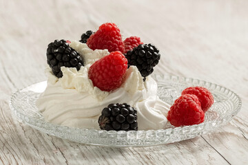 Pavlova cake on a glass plate. Festive dessert. Copy space. 