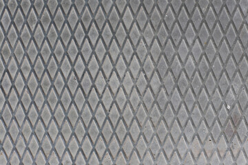 Detail of a rhombuses pattern from a manhole cover, perfect for a background. Old real metal style.