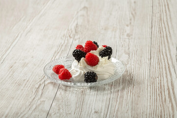 Pavlova cake on a glass plate. Festive dessert. Copy space. 