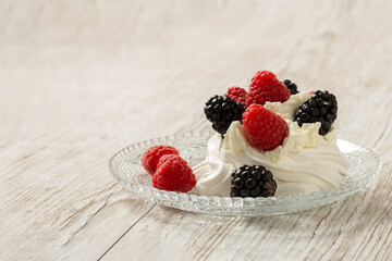 Pavlova cake on a glass plate. Festive dessert. Copy space. 