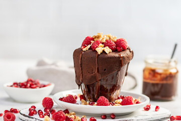 Raspberry mug cake in a glass on light background
