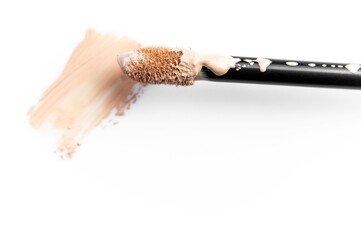 Concealer brush for face makeup isolated on white background. Liquid foundation, decorative cosmetics. Foundation face make-up samples, texture of face concealer. Make up smears. Cosmetic background