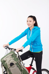 Young woman with backpack,taking a bike