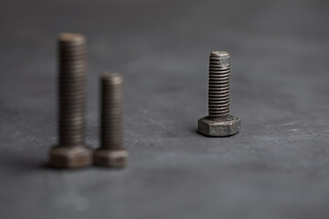 The three bolts represent three people. Items on a dark background.