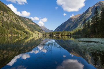 Obraz na płótnie Canvas Idyllic mountain lake in the austrian alps with blue sky