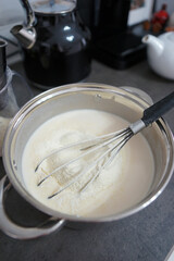 Fototapeta na wymiar Pancake dough in a pan on the table in the kitchen