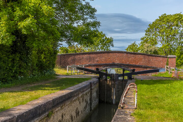 Fototapeta premium A view across a lock gate at the village of Napton, Warwickshire in summertime