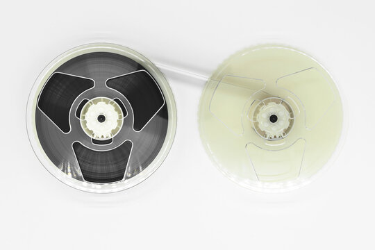 Abstract composition of video home system VHS tape reels on white background with copy space