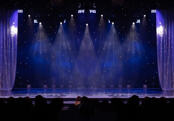 An empty stage of the theater, lit by spotlights and smoke before the performance	