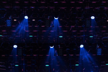An empty stage of the theater, lit by spotlights and smoke before the performance
