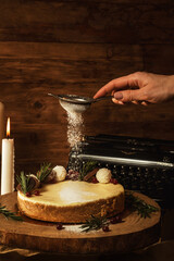 New York cheesecake or classic cheesecake, on a wood tray, garnished with cranberries and chocolate and powdered sugar