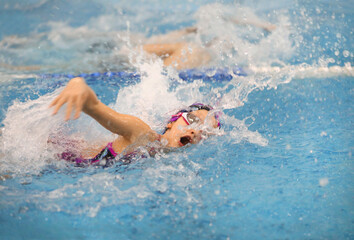 little girl swimming  in pool