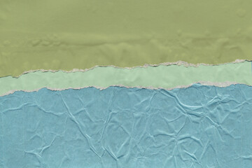 Colorful torn paper collage close-up. Texture made from various paper and cardboard parts. Damaged old paper background. Vintage blank wallpaper. Material design backdrop.